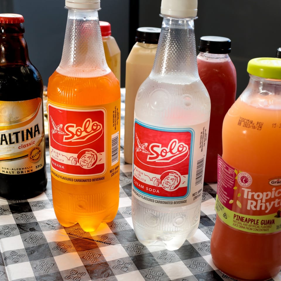 A variety of Caribbean beverages, including Solo banana and cream sodas, and Tropic Rhythms pineapple guava juice.